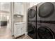 A laundry room featuring stacked washer and dryer units and a utility sink at 2166 N Steele --, Mesa, AZ 85207