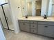 Elegant bathroom with double vanity, sleek black fixtures, and glass-enclosed shower at 22382 W Monona Ln, Surprise, AZ 85387