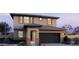 Stunning two-story home featuring a modern design, attached two-car garage, and beautifully landscaped front yard at 22382 W Monona Ln, Surprise, AZ 85387