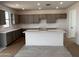 Modern kitchen with ample cabinet space, sleek countertops, a large center island, and stainless steel appliances at 22382 W Monona Ln, Surprise, AZ 85387