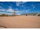 View of backyard and house showing desert landscaping and bright, sunny skies at 2248 S Nikki Ln, Maricopa, AZ 85139