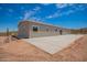 View of the back of the house featuring an expansive concrete patio in a desert landscape at 2248 S Nikki Ln, Maricopa, AZ 85139