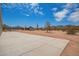 Expansive concrete patio with desert landscape and blue skies with cloud cover at 2248 S Nikki Ln, Maricopa, AZ 85139