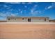 Backyard view of home with desert landscaping and clear blue skies with cloud cover at 2248 S Nikki Ln, Maricopa, AZ 85139