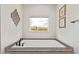 Contemporary bathroom with a deep soaking tub and scenic desert view at 2248 S Nikki Ln, Maricopa, AZ 85139