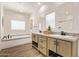 Bright bathroom with double vanities, soaking tub, and modern fixtures at 2248 S Nikki Ln, Maricopa, AZ 85139