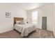Charming bedroom with carpet, woven headboard, side table and decor, and plenty of natural light at 2248 S Nikki Ln, Maricopa, AZ 85139