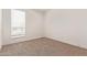 This carpeted bedroom has natural light and neutral walls at 2248 S Nikki Ln, Maricopa, AZ 85139