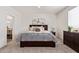 Comfortable bedroom with a plush bed, stylish dresser, and soft, neutral tones at 2248 S Nikki Ln, Maricopa, AZ 85139