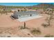 New desert home features neutral siding, gray roof, and a rock garden adding to its appeal at 2248 S Nikki Ln, Maricopa, AZ 85139