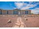 Single-story home featuring desert landscaping, with stone pathway, seen from driveway at 2248 S Nikki Ln, Maricopa, AZ 85139