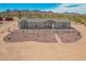 Exterior of home showing desert landscaping with red rock, native vegetation, and blue skies at 2248 S Nikki Ln, Maricopa, AZ 85139