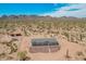 Desert home with neutral siding, gray roof, and natural desert landscaping provides a tranquil environment at 2248 S Nikki Ln, Maricopa, AZ 85139