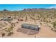 Desert home with neutral siding, gray roof, and desert landscaping offers serene living in a natural environment at 2248 S Nikki Ln, Maricopa, AZ 85139