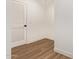 Bright hallway featuring modern wood-look floors and a white door with horizontal panels at 2248 S Nikki Ln, Maricopa, AZ 85139