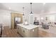 Modern kitchen featuring island, stainless appliances, and an open layout to the living space at 2248 S Nikki Ln, Maricopa, AZ 85139