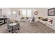 Open concept living area with plush seating, decor, and large windows filling the space at 2248 S Nikki Ln, Maricopa, AZ 85139