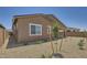 The back exterior shows a fenced-in yard, low-maintenance landscaping, and a covered patio at 25338 N 150Th Ln, Surprise, AZ 85387