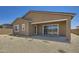 The back exterior features a neutral stucco with an open patio perfect for outdoor dining and entertaining at 25338 N 150Th Ln, Surprise, AZ 85387