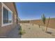 The expansive backyard is designed with desert landscaping for minimal upkeep, perfect for enjoying the outdoors at 25338 N 150Th Ln, Surprise, AZ 85387