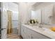 Well-lit bathroom featuring a double vanity, contemporary fixtures, and neutral color palette at 25338 N 150Th Ln, Surprise, AZ 85387