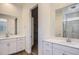 Bright bathroom with double vanity and mirror with an opening to the walk-in closet at 25338 N 150Th Ln, Surprise, AZ 85387