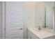 Bright bathroom featuring a white vanity, a large mirror, and a white door at 25338 N 150Th Ln, Surprise, AZ 85387