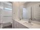 Bright bathroom with double vanity, large mirror, and white subway tile detail in the tub at 25338 N 150Th Ln, Surprise, AZ 85387