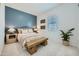 Stylish bedroom showcasing a cozy bed with woven headboard and an accent wall at 25338 N 150Th Ln, Surprise, AZ 85387
