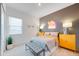 Modern bedroom featuring neon bowling sign, grey accent wall, and sleek furniture at 25338 N 150Th Ln, Surprise, AZ 85387