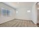 Well-lit bedroom featuring neutral carpet, white walls, and windows with blinds for natural light at 25338 N 150Th Ln, Surprise, AZ 85387
