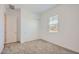 Bright bedroom with plush neutral carpet, a window, and white sliding closet doors at 25338 N 150Th Ln, Surprise, AZ 85387