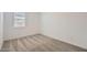 Bright bedroom featuring plush neutral carpet, a window with blinds, and white walls at 25338 N 150Th Ln, Surprise, AZ 85387