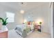 Bright bedroom with soft natural light, a vibrant plant, and modern accents at 25338 N 150Th Ln, Surprise, AZ 85387