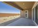 A large covered patio provides shade and a seamless transition to the low-maintenance landscaped backyard at 25338 N 150Th Ln, Surprise, AZ 85387