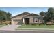 Charming single-story home with a two-car garage, well-maintained lawn, and beautiful desert landscaping at 25338 N 150Th Ln, Surprise, AZ 85387