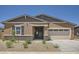 Charming single-story home featuring a two-car garage, neutral stucco, and desert landscaping for easy maintenance at 25338 N 150Th Ln, Surprise, AZ 85387