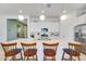 Stylish kitchen featuring a spacious island with seating, pendant lighting, and sleek white cabinetry at 25338 N 150Th Ln, Surprise, AZ 85387