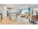 Open-concept living room and kitchen with a large island, stainless steel appliances, and modern finishes at 25338 N 150Th Ln, Surprise, AZ 85387