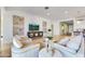 Bright and airy living room featuring stylish furnishings, wood-look flooring, and contemporary decor at 25338 N 150Th Ln, Surprise, AZ 85387