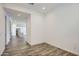 An open floor plan leads to a modern kitchen, enhancing the space with sleek, hardwood floors and contemporary design at 25338 N 150Th Ln, Surprise, AZ 85387