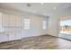 Bright and airy living space with hardwood floors, large windows, and a convenient built-in cabinet space at 25338 N 150Th Ln, Surprise, AZ 85387