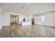 Open living space featuring hardwood floors and a modern kitchen with white cabinetry and stainless steel appliances at 25338 N 150Th Ln, Surprise, AZ 85387