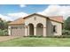 Charming stucco home boasts a well-manicured lawn, arched entryway and a convenient attached garage at 25453 N 176Th Ave, Surprise, AZ 85387