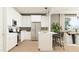 Modern kitchen featuring sleek white cabinets, stainless steel appliances, and an island with seating at 25453 N 176Th Ave, Surprise, AZ 85387