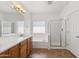 Bright bathroom features dual sinks, soaking tub, glass shower, and tile flooring at 25617 W St James Ave, Buckeye, AZ 85326
