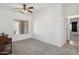 Carpeted bedroom featuring a window, a ceiling fan, and a view of the doorway at 25617 W St James Ave, Buckeye, AZ 85326