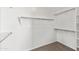 Walk-in closet with carpeted floor and white shelving at 25617 W St James Ave, Buckeye, AZ 85326