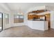 Open concept dining room with sliding glass door, modern light fixture, and view into the kitchen at 25617 W St James Ave, Buckeye, AZ 85326