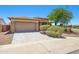 Single-story home with a two-car garage, desert landscaping, and a well-kept front lawn at 25617 W St James Ave, Buckeye, AZ 85326